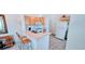 Charming kitchen equipped with white appliances and a convenient breakfast bar at 300 Falling Water Dr, Kissimmee, FL 34759