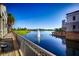 Stunning lakeside view with a fountain, lush landscaping, and elegant buildings, showcasing community amenities at 300 Falling Water Dr, Kissimmee, FL 34759