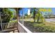 Screened lanai view overlooking lush landscaping, shrubbery and the neighborhood street at 300 Falling Water Dr, Kissimmee, FL 34759