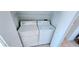 Laundry room with a white washer, dryer, and wire shelving above at 300 Falling Water Dr, Kissimmee, FL 34759