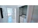 Convenient laundry room with washer and dryer, adjacent to a tiled bathroom at 300 Falling Water Dr, Kissimmee, FL 34759