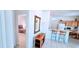 Open living space with tile floors, a dining area, and a glimpse of the bedroom at 300 Falling Water Dr, Kissimmee, FL 34759