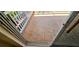 Close-up of the tiled floor of the patio, with white railings and the sliding door to the unit at 300 Falling Water Dr, Kissimmee, FL 34759