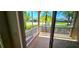 View of the community from the screened-in patio with white railings and tiled flooring at 300 Falling Water Dr, Kissimmee, FL 34759