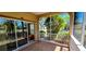 View of the screened-in patio with tiled floor and sliding door entrance to the home at 300 Falling Water Dr, Kissimmee, FL 34759