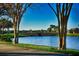 Scenic community pond with bridge, lush landscaping, and serene waterfront views at 300 Falling Water Dr, Kissimmee, FL 34759