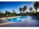 Beautiful pool area with clear blue water, palm trees, and lounge chairs, creating an ideal relaxation spot at 300 Falling Water Dr, Kissimmee, FL 34759