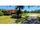 Pool with lounge chairs and a building with a red tiled roof, surrounded by lush landscaping at 300 Falling Water Dr, Kissimmee, FL 34759