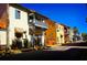 Charming street view of vibrant, colorful buildings with balconies and awnings on a sunny day at 300 Falling Water Dr, Kissimmee, FL 34759