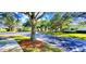 Beautiful street view with mature trees lining the road and sidewalks in a quiet residential neighborhood at 300 Falling Water Dr, Kissimmee, FL 34759