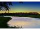 Beautiful water view at sunset with a golf course in the background, a peaceful and scenic landscape at 300 Falling Water Dr, Kissimmee, FL 34759