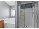 Bathroom with tub and separate glass-enclosed shower at 323 Azincourt Ln, Kissimmee, FL 34759