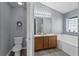 Bright bathroom with double sink vanity, toilet, and separate tub and shower at 323 Azincourt Ln, Kissimmee, FL 34759
