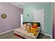 Bedroom with two tone colored walls, wood-look floors and a futon with a 