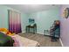 Bedroom with two tone colored walls, wood-look floors and a basket ball hoop toy in the corner of the room at 323 Azincourt Ln, Kissimmee, FL 34759