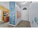 Inviting entryway with wood-look floors and modern decor, leading to the kitchen at 323 Azincourt Ln, Kissimmee, FL 34759