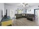 Spacious living room with ample seating and natural light, featuring sleek wood-look floors at 323 Azincourt Ln, Kissimmee, FL 34759