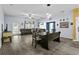Open-concept living room featuring wood-look floors, neutral walls, and dining area at 323 Azincourt Ln, Kissimmee, FL 34759