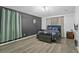 Main bedroom with flower wall decor, windows, and modern furnishings at 323 Azincourt Ln, Kissimmee, FL 34759