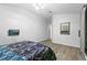 Bedroom features a mounted TV and ample natural light at 323 Azincourt Ln, Kissimmee, FL 34759