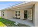 Covered patio with an open door and furniture, providing a comfortable outdoor space for relaxation at 323 Azincourt Ln, Kissimmee, FL 34759
