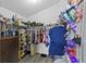 Spacious walk-in closet with shelving, rods, and ample storage space for clothes, shoes, and accessories at 323 Azincourt Ln, Kissimmee, FL 34759