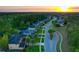 Sunset aerial view of neighborhood featuring homes with well-manicured lawns at 3245 Heirloom Rose Pl, Oviedo, FL 32766
