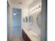 Bathroom with double sinks and large mirrors leading to the bedroom at 3245 Heirloom Rose Pl, Oviedo, FL 32766