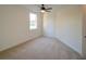 This bedroom has carpeted floors, a ceiling fan, and a window letting in natural light at 3245 Heirloom Rose Pl, Oviedo, FL 32766