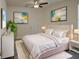 Cozy bedroom with modern décor, plush bedding, and a decorative plant at 3245 Heirloom Rose Pl, Oviedo, FL 32766