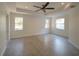 Spacious bedroom features a tray ceiling, ceiling fan, and neutral paint at 3245 Heirloom Rose Pl, Oviedo, FL 32766