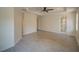 Bright bedroom features tiled floor, tray ceiling, and neutral wall color at 3245 Heirloom Rose Pl, Oviedo, FL 32766