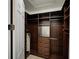 Walk-in closet with custom wood shelving and storage drawers for organization at 3245 Heirloom Rose Pl, Oviedo, FL 32766