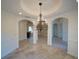 Open dining area with decorative columns, tile flooring, and an ornate chandelier at 3245 Heirloom Rose Pl, Oviedo, FL 32766