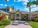 Charming home featuring stone accents, a brick driveway, and lush tropical landscaping at 3245 Heirloom Rose Pl, Oviedo, FL 32766