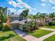 Beautiful two-story home with a well-manicured lawn, mature landscaping, and a brick driveway at 3245 Heirloom Rose Pl, Oviedo, FL 32766