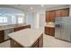 Open-concept kitchen with stainless steel appliances and center island and wood cabinets at 3245 Heirloom Rose Pl, Oviedo, FL 32766