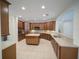 Large kitchen with island, wood cabinets, stainless appliances, and tile flooring at 3245 Heirloom Rose Pl, Oviedo, FL 32766