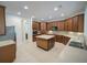 Spacious kitchen with wood cabinetry, a central island, and tile flooring at 3245 Heirloom Rose Pl, Oviedo, FL 32766