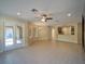 View of open floor plan living room showing access to kitchen and tiled floors, with an open doorway to another room at 3245 Heirloom Rose Pl, Oviedo, FL 32766