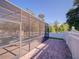 The screened-in pool area, surrounded by a white fence, features a waterfall and ample space for recreation at 3245 Heirloom Rose Pl, Oviedo, FL 32766