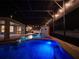 Enclosed pool area with waterfall feature, hot tub, outdoor lighting, and patio area at 3245 Heirloom Rose Pl, Oviedo, FL 32766