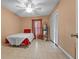Bright bedroom featuring tile flooring, a single bed, and a convenient closet at 333 Lake Howard Dr Nw # 204D, Winter Haven, FL 33880