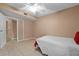 Minimalist bedroom with tile floors, single bed, and ample space at 333 Lake Howard Dr Nw # 204D, Winter Haven, FL 33880