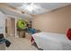 A compact bedroom space featuring tile flooring and a ceiling fan at 333 Lake Howard Dr Nw # 204D, Winter Haven, FL 33880