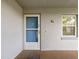 Apartment entrance featuring a screen door, small window, and a welcome mat at 333 Lake Howard Dr Nw # 204D, Winter Haven, FL 33880