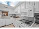 Bright kitchen with white appliances, marble countertops, and ample cabinet space at 333 Lake Howard Dr Nw # 204D, Winter Haven, FL 33880