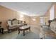 Living room featuring carpet, a chandelier, and elegant furniture at 333 Lake Howard Dr Nw # 204D, Winter Haven, FL 33880