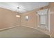 Living room with carpet and a pass through to the kitchen at 333 Lake Howard Dr Nw # 204D, Winter Haven, FL 33880