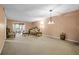 Spacious living room with carpet, a chandelier, and elegant furniture at 333 Lake Howard Dr Nw # 204D, Winter Haven, FL 33880